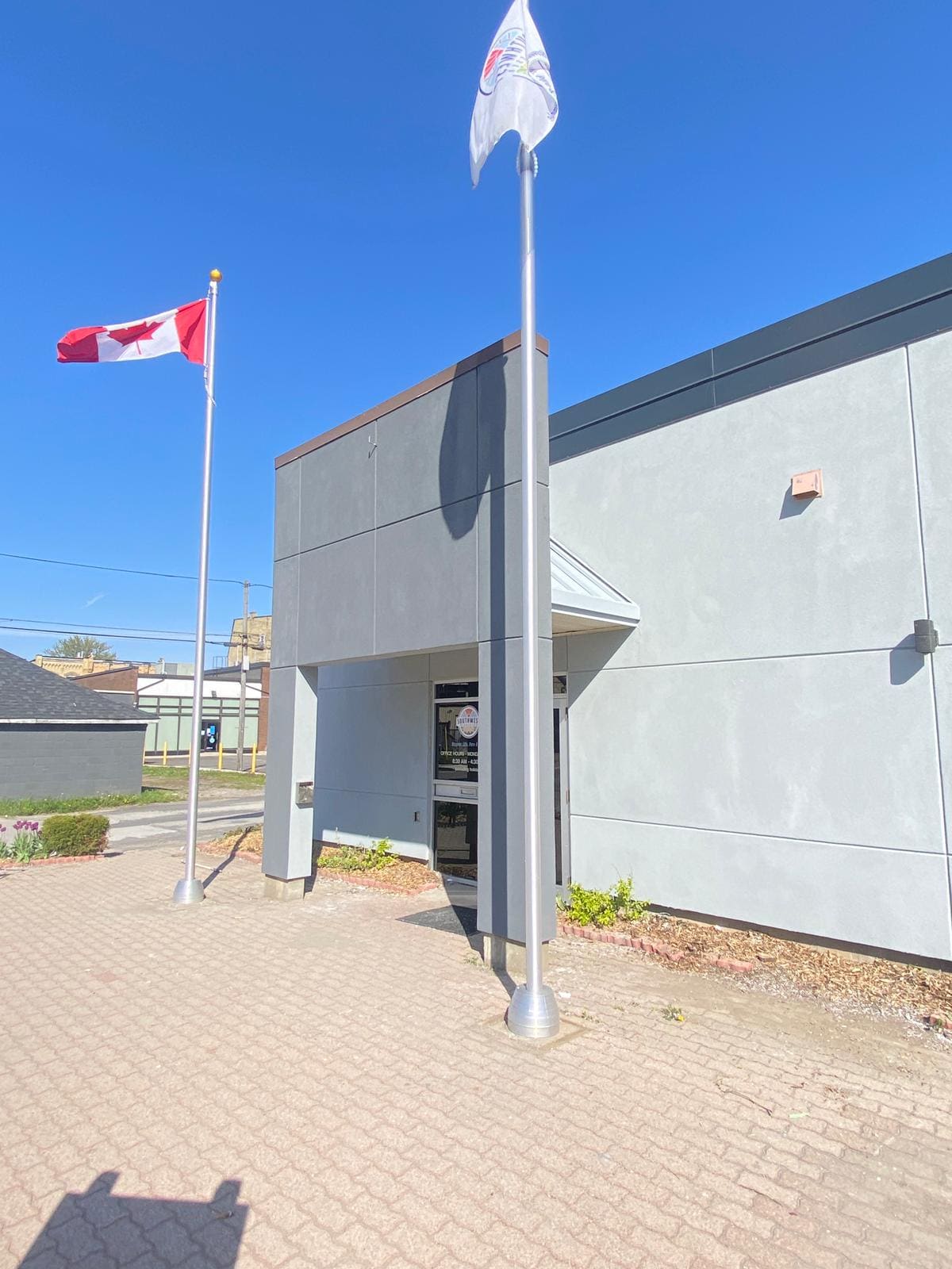 Commercial building entrance repaint with flagpoles