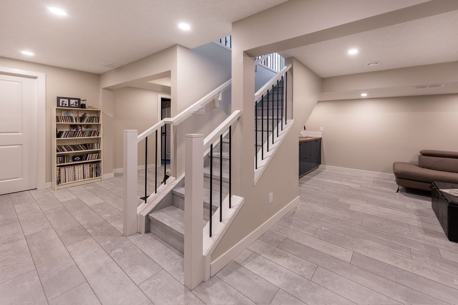 Finished basement renovation with tiled stairs and living space